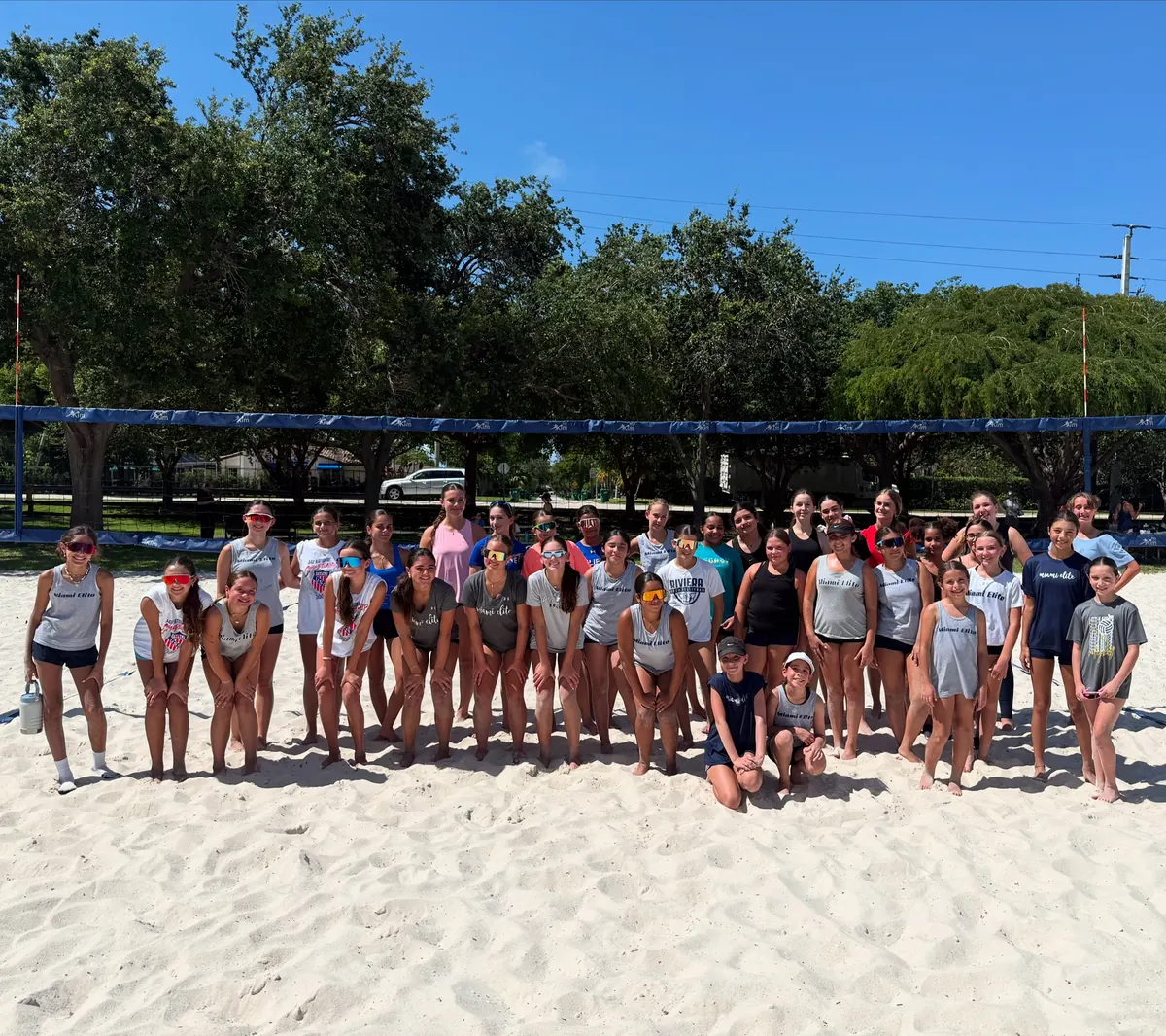 Mamu Beach athletes and coaches gathered together on the sand court