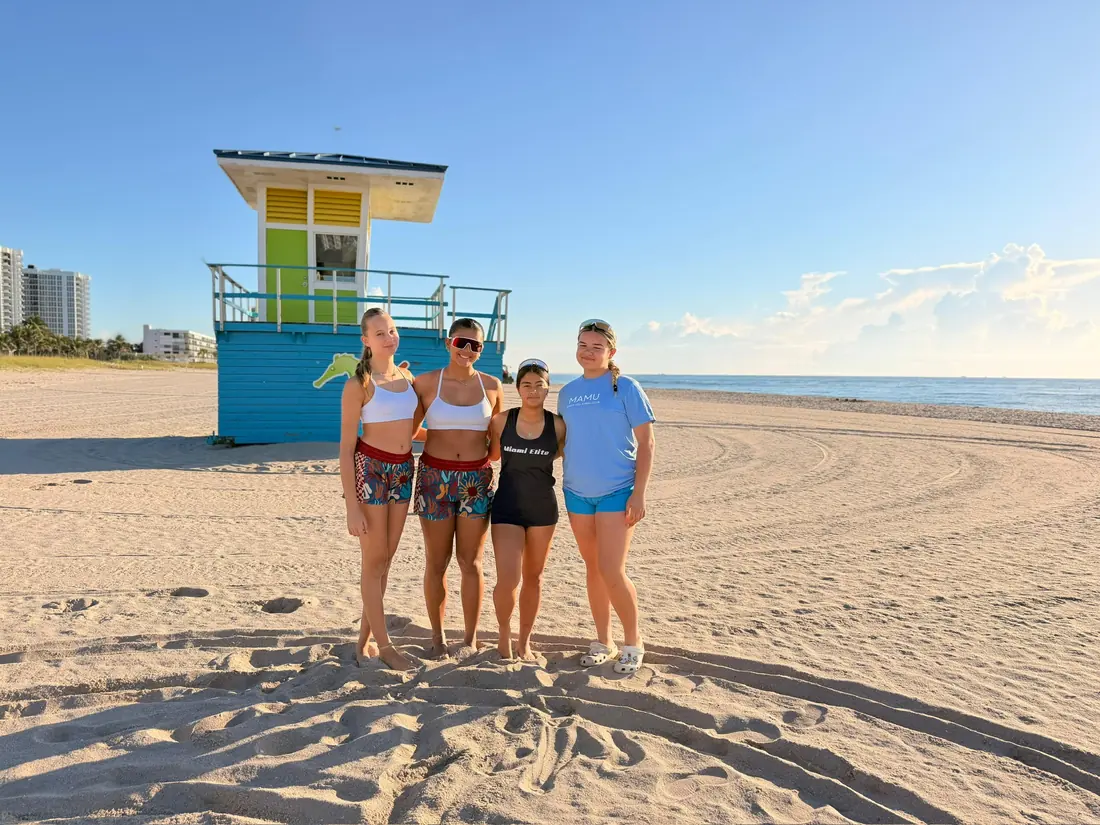 Mamu Beach athletes together on the beach by the lifeguard stand