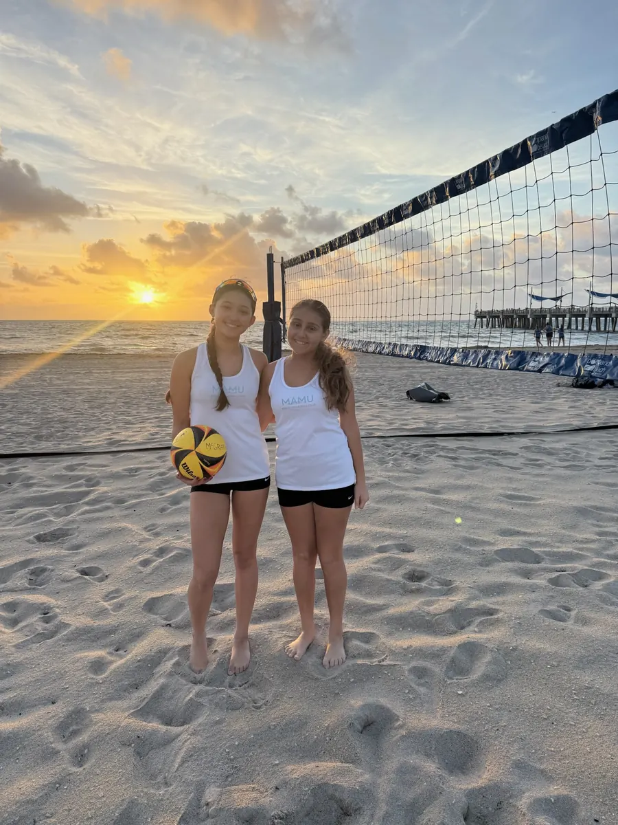 Two Mamu Beach athletes at the net in warm evening light